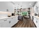 Bright, open-concept kitchen with white cabinets, stainless appliances, and a view into the living area at 1015 Tallacoe Trl, New Smyrna Beach, FL 32168