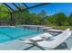 Gorgeous pool with fountains and underwater seating, set against a backdrop of lush trees at 1015 Tallacoe Trl, New Smyrna Beach, FL 32168