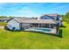 Beautiful rear view of the property featuring the screened-in pool and spacious backyard at 1015 Tallacoe Trl, New Smyrna Beach, FL 32168