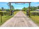 Grand entrance to Tallacoe Farms with a long, winding driveway and picturesque scenery at 1015 Tallacoe Trl, New Smyrna Beach, FL 32168