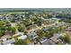 Aerial view of a serene neighborhood, complete with lush trees and a tranquil lake nearby at 1054 Abeline Dr, Deltona, FL 32725