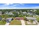 An aerial view of a charming neighborhood, highlighting mature trees and well-maintained homes at 1054 Abeline Dr, Deltona, FL 32725