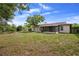 A large backyard with a screened-in porch, perfect for outdoor entertaining and relaxation at 1054 Abeline Dr, Deltona, FL 32725