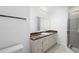 A bathroom featuring a marble counter, cabinetry and framed mirror at 1054 Abeline Dr, Deltona, FL 32725