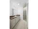 A bathroom featuring a marble counter, cabinetry and framed mirror at 1054 Abeline Dr, Deltona, FL 32725