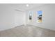 Bedroom with white tiled floors and closet with natural sunlight at 1054 Abeline Dr, Deltona, FL 32725