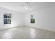 Bright bedroom with tile floors, ceiling fan, and large windows at 1054 Abeline Dr, Deltona, FL 32725
