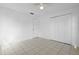 Empty bedroom featuring a ceiling fan, closet, tile floors, and a door at 1054 Abeline Dr, Deltona, FL 32725
