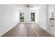 This bedroom features wood flooring, and a window overlooking the yard at 1054 Abeline Dr, Deltona, FL 32725