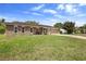 Charming brick home with a well-manicured front lawn and a cozy bench on the front porch at 1054 Abeline Dr, Deltona, FL 32725