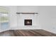 Close-up of a whitewashed brick fireplace with a hearth and wooden mantel at 1054 Abeline Dr, Deltona, FL 32725