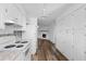 Spacious white kitchen with ample cabinets and a view of the fireplace in the living room at 1054 Abeline Dr, Deltona, FL 32725