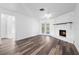 View of the living room featuring laminate floors, a ceiling fan, and a brick fireplace at 1054 Abeline Dr, Deltona, FL 32725