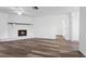 View of the living room featuring laminate floors, a ceiling fan, and a brick fireplace at 1054 Abeline Dr, Deltona, FL 32725