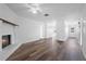 View of the living room featuring laminate floors, a ceiling fan, and a brick fireplace at 1054 Abeline Dr, Deltona, FL 32725
