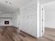 Spacious living room with white brick fireplace and wood-look floors at 1054 Abeline Dr, Deltona, FL 32725