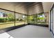 A screened patio overlooking a grassy yard at 1054 Abeline Dr, Deltona, FL 32725
