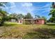 View of the backyard and exterior of the home with a screen patio and landscaping at 1160 Fountainhead Dr, Deltona, FL 32725