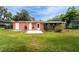 The home's exterior shows doors leading to the backyard and colorful landscaping at 1160 Fountainhead Dr, Deltona, FL 32725