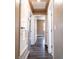 Hallway featuring hardwood floors, neutral walls and white doors at 1160 Fountainhead Dr, Deltona, FL 32725