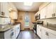 Bright kitchen featuring stainless steel appliances, granite countertops, and white cabinetry at 1160 Fountainhead Dr, Deltona, FL 32725