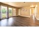 Open living room with wood floors, large windows, and neutral walls at 1160 Fountainhead Dr, Deltona, FL 32725