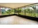 Screened-in patio with tiled flooring and view to backyard at 1160 Fountainhead Dr, Deltona, FL 32725