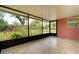 The tiled patio is screened with views of the colorful backyard at 1160 Fountainhead Dr, Deltona, FL 32725