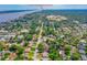 Aerial view of neighborhood and home with tree coverage near Historic Downtown Ormond Beach at 1206 Parkside Dr, Ormond Beach, FL 32174