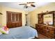 Bedroom featuring hardwood floors, yellow walls, closet, and wooden dresser at 1206 Parkside Dr, Ormond Beach, FL 32174