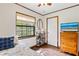 A cozy bedroom with wood floors, window, and dresser, bathed in natural light at 1206 Parkside Dr, Ormond Beach, FL 32174