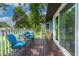 View of a cozy wooden deck with blue chairs and table, perfect for outdoor relaxation and entertaining at 1206 Parkside Dr, Ormond Beach, FL 32174
