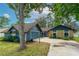 This exterior features an attached garage and a walkway to the front door at 1206 Parkside Dr, Ormond Beach, FL 32174