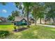 Landscaped front yard with lush lawn and a bench at 1206 Parkside Dr, Ormond Beach, FL 32174