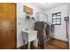 Laundry room features a utility sink, modern appliances, and ample storage at 1206 Parkside Dr, Ormond Beach, FL 32174