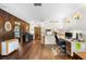 View of the hardwood-floored living room showing the natural light, wood accents, and view into the kitchen at 1206 Parkside Dr, Ormond Beach, FL 32174