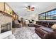 Spacious living room featuring a brick fireplace, plush rug, leather sectional, and an open layout at 1206 Parkside Dr, Ormond Beach, FL 32174