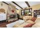 Comfortable living room featuring a stone fireplace, wood beams, and large bay window offering natural light at 1206 Parkside Dr, Ormond Beach, FL 32174