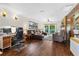 Spacious living room with hardwood floors, a brick fireplace, and a walkout to a private balcony at 1206 Parkside Dr, Ormond Beach, FL 32174
