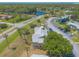An aerial view of the property with lots of trees, a nearby lake, roads, landscaping and condominium buildings at 124 Golden Eye Dr # A, Daytona Beach, FL 32119