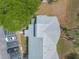 Birds eye view of condominium rooftops, parking lot, trees and landscaping elements in a residential setting at 124 Golden Eye Dr # A, Daytona Beach, FL 32119