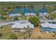 Aerial shot showcasing lakeside condos featuring screened lanais, lush landscaping, and convenient parking at 124 Golden Eye Dr # A, Daytona Beach, FL 32119