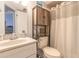 Well-lit bathroom featuring a vanity with sink, a toilet, and storage shelves for toiletries at 124 Golden Eye Dr # A, Daytona Beach, FL 32119