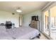 Spacious bedroom featuring a comfortable bed, work desk, and access to an outdoor deck at 124 Golden Eye Dr # A, Daytona Beach, FL 32119