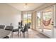 Bright dining area with modern chairs, a glass table, and a view of the screened in patio at 124 Golden Eye Dr # A, Daytona Beach, FL 32119