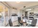 Open dining area with a glass table, kitchen access, and a view of the outdoor patio at 124 Golden Eye Dr # A, Daytona Beach, FL 32119
