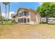 Exterior view of the beautiful home featuring a screened lanai overlooking a lush yard at 124 Golden Eye Dr # A, Daytona Beach, FL 32119