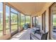 Relaxing sunroom with cushioned seating, offering views of the lush outdoor landscape at 124 Golden Eye Dr # A, Daytona Beach, FL 32119