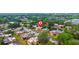 Community aerial view showcasing residences, parking, and pond views with mature landscaping at 135 Moonstone Ct, Port Orange, FL 32129