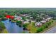Expansive aerial view of a townhome community near a serene pond and lush greenery, highlighting its appeal at 135 Moonstone Ct, Port Orange, FL 32129